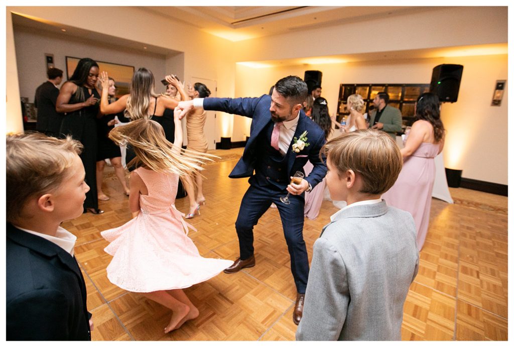 groom dancing with child