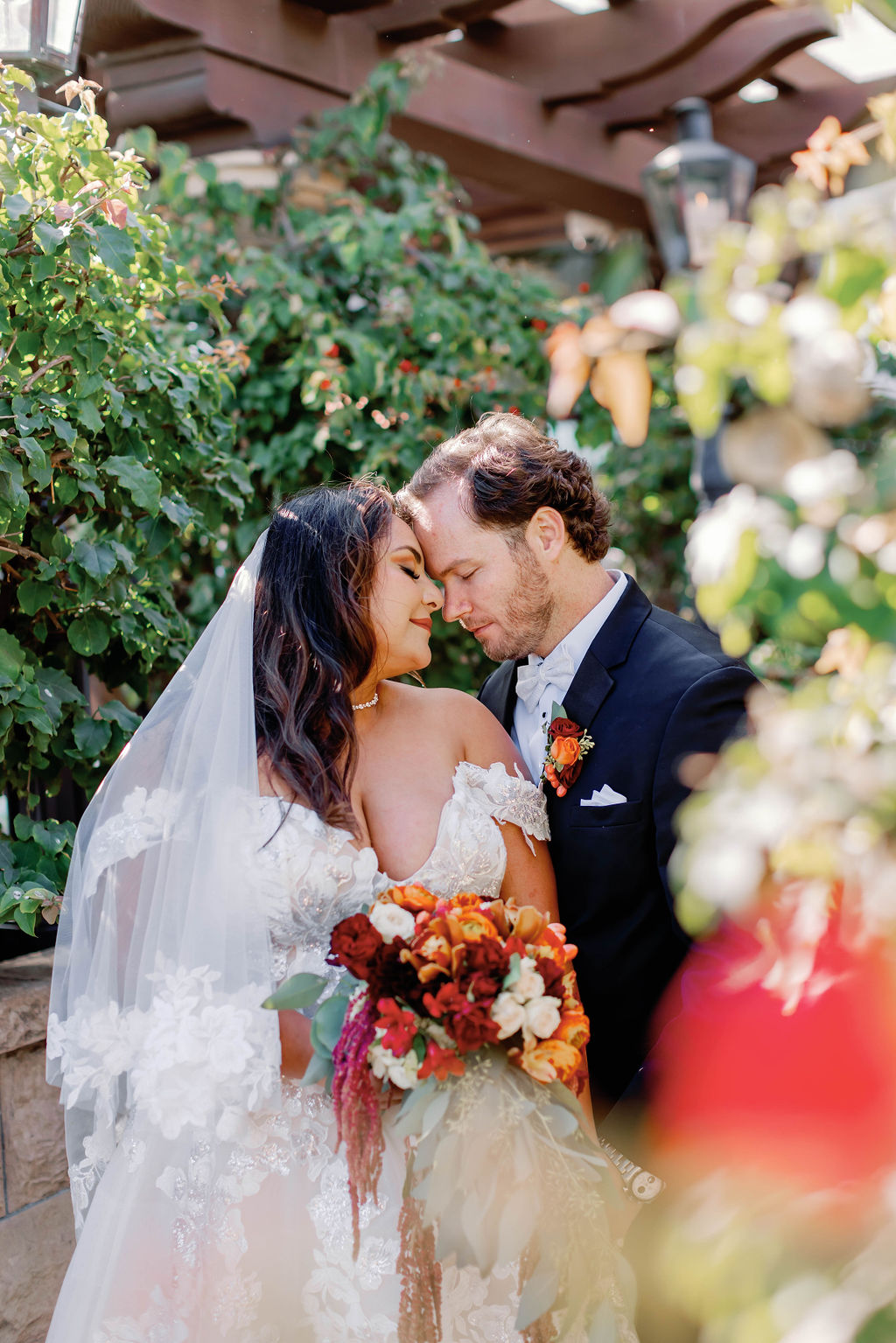 Bride and groom forehead to forehead for a photo at Mission Santa Barbara wedding | Photo by Sarah Block Photography