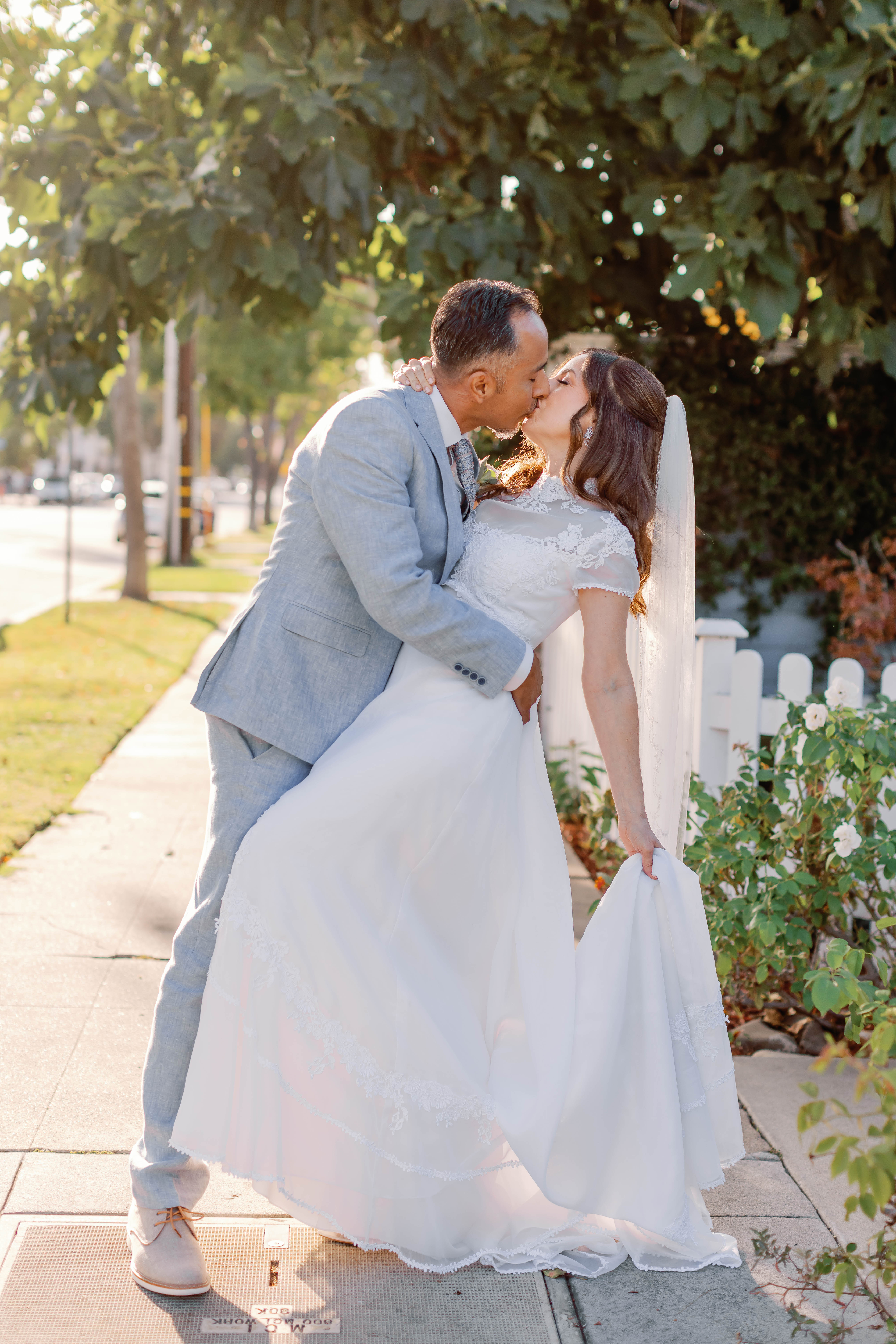 Bride and groom kiss in the sunlight | Photo by Sarah Block Photography