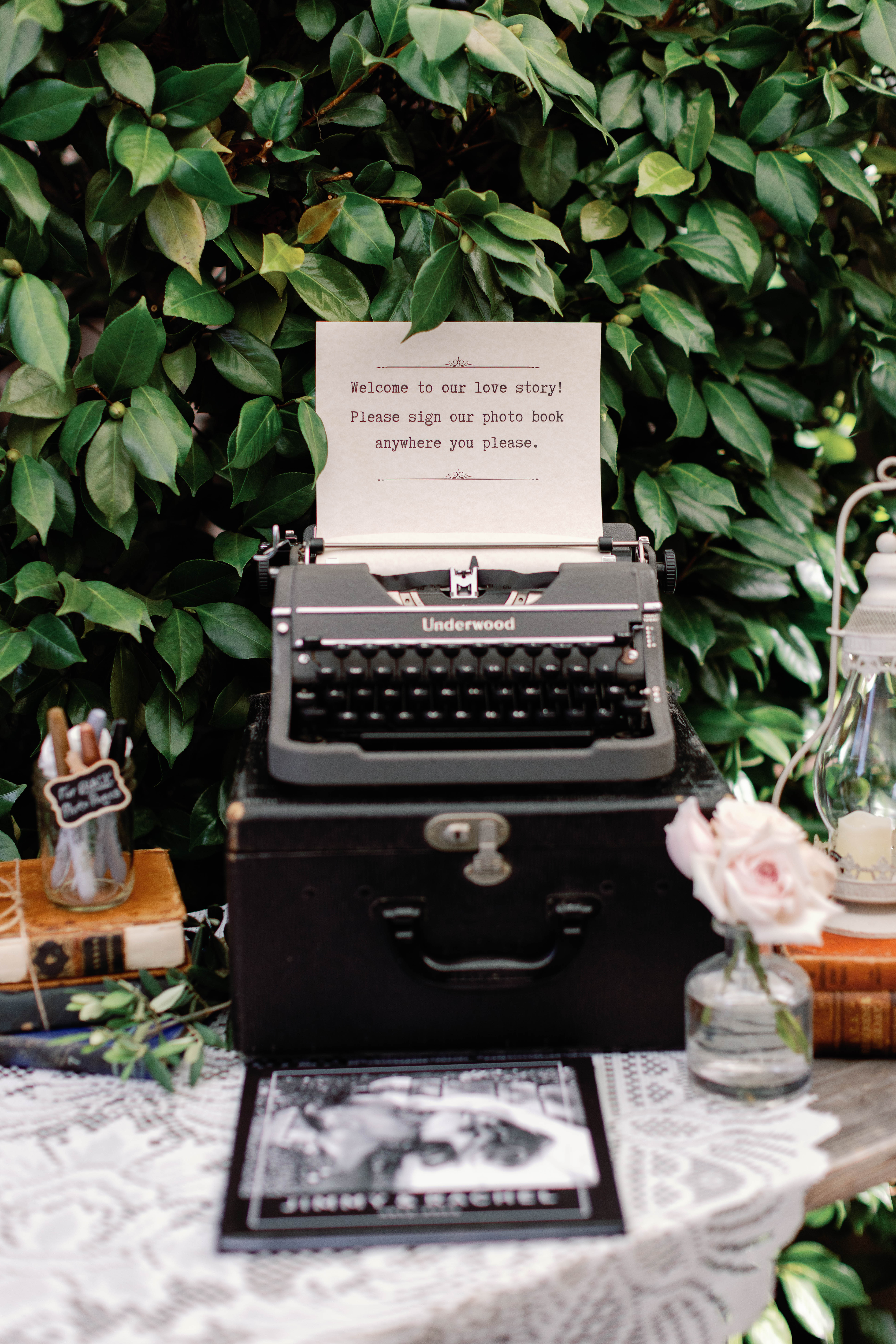 Vintage typewriter on the escort card table at the wedding of Jimmy and Rachel hosted at Chapel of Orange | Photo by Sarah Block Photography