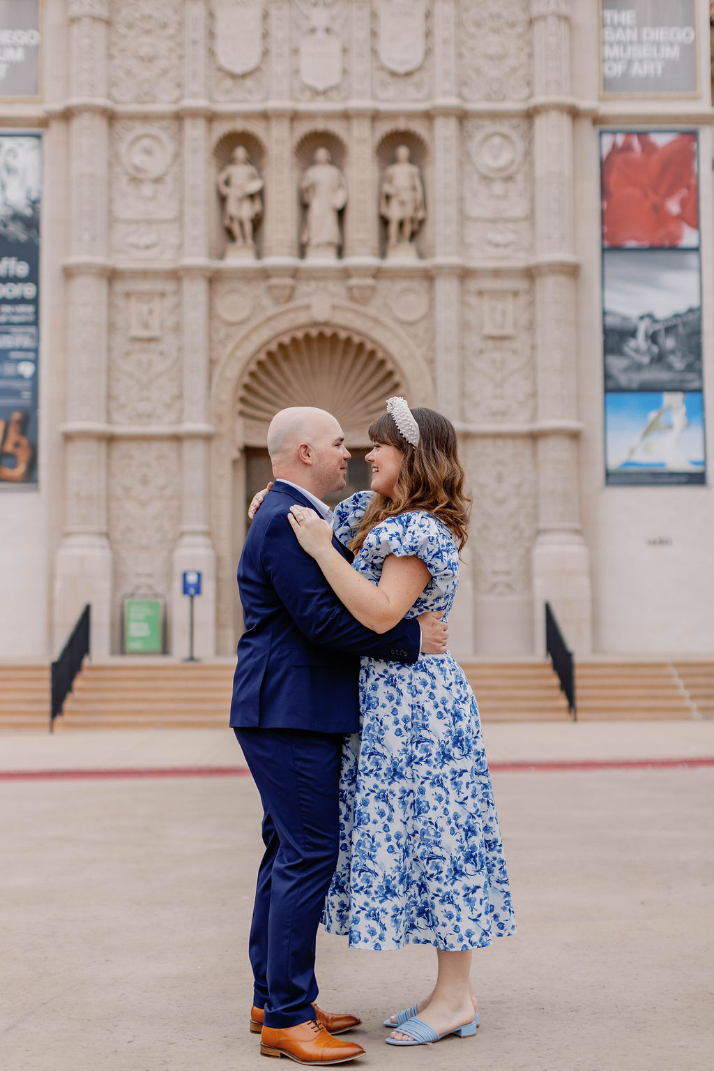 Engagement photo of Jimmy and Hannah  dancing and embracing outside  at San Diego Museum of art. |Photo by California Photographer Sarah Block Photography