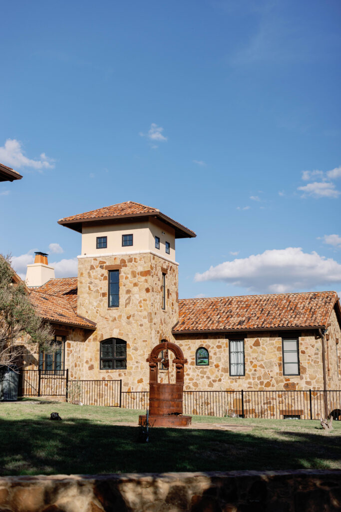 Two Streams One Heart Wedding Venue in Spicewood Texas with Spanish influenced stone building | Photo by California Photographer Sarah Block Photography