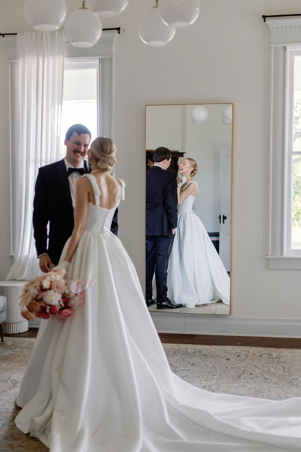 Bride and groom steal away and enjoy a moment alone in front of the mirror at the Grand Lady wedding venue in Austin Texas. | Photo by Sarah Block Photography