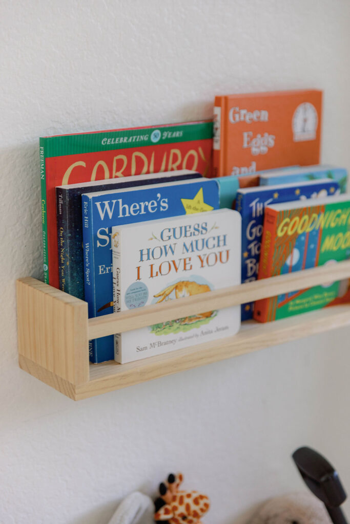 Baby Marley's bookshelf in his nursery with childhood classics such as "Guess How Much I Love You" and "Goodnight Moon" | Photo by Sarah of Sarah Block Photography